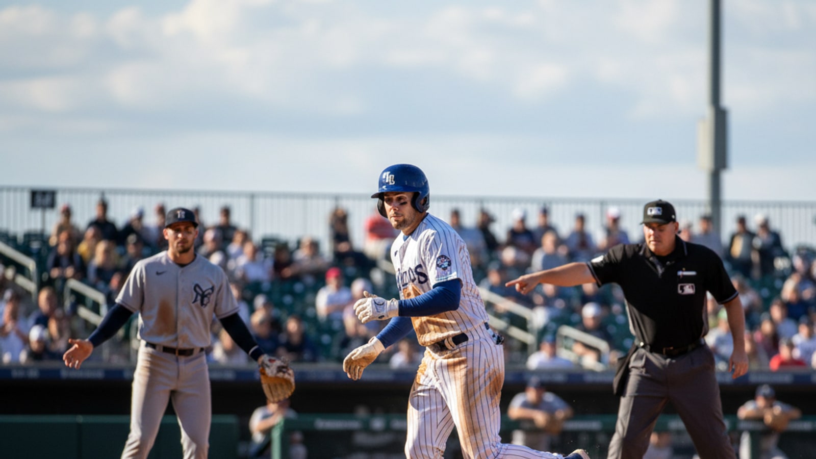 Can a batter be awarded first base if the ball strikes the ground?