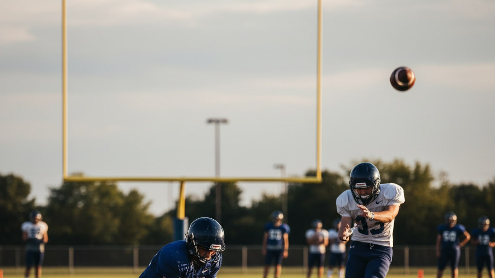 How does a football holder hold the ball?