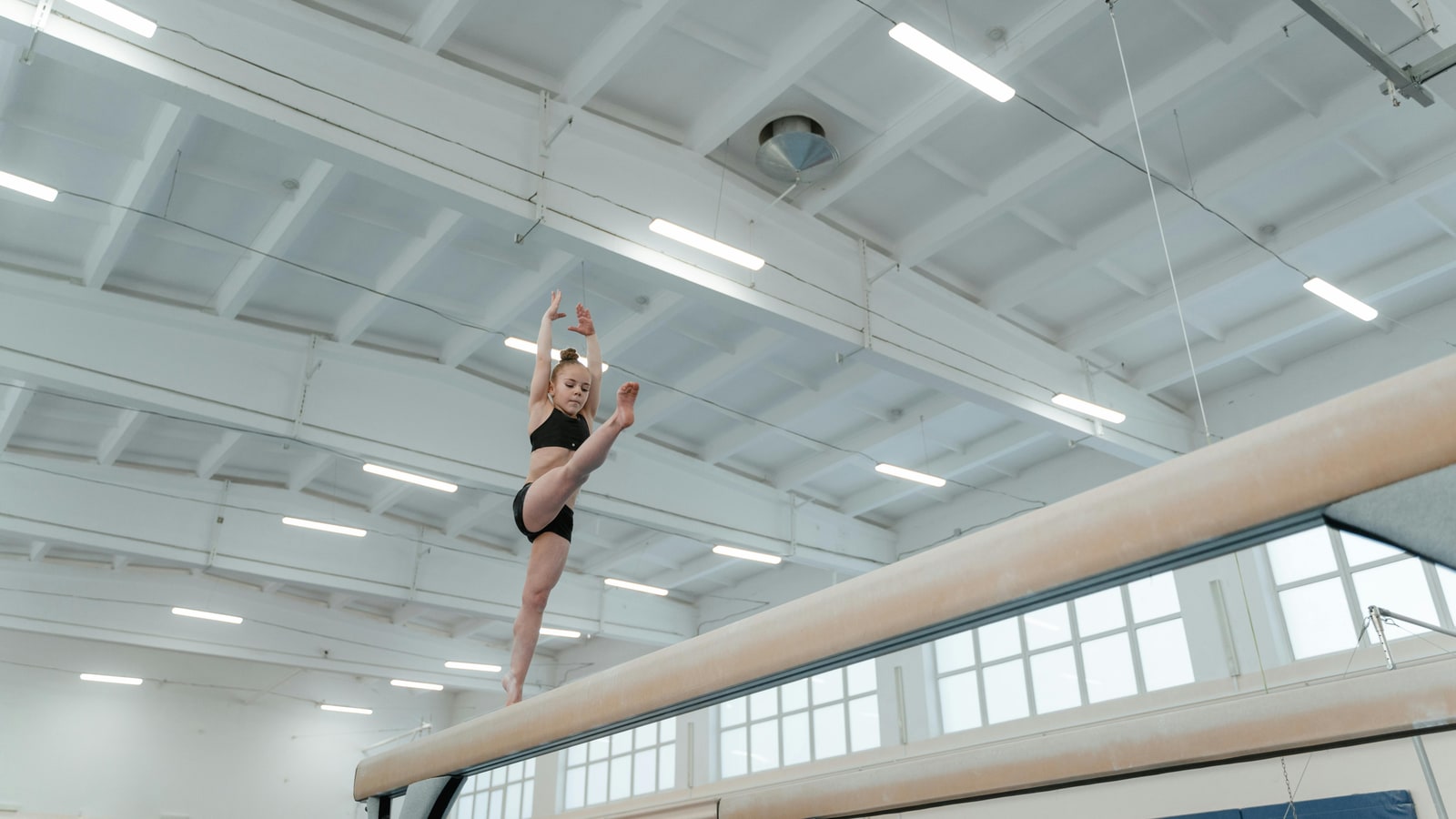Why do gymnasts raise their arms?