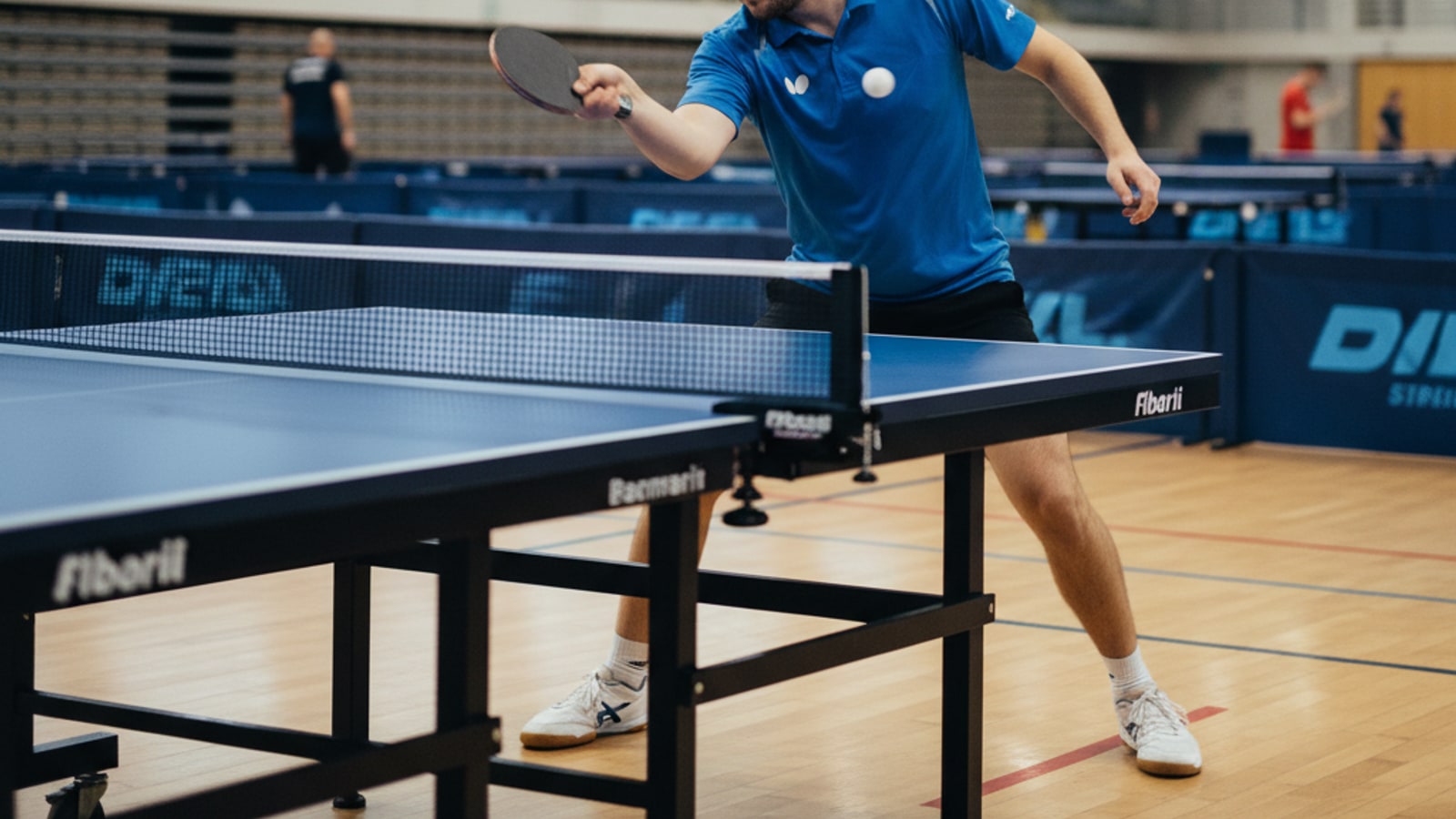 What is the backhand stroke in table tennis?