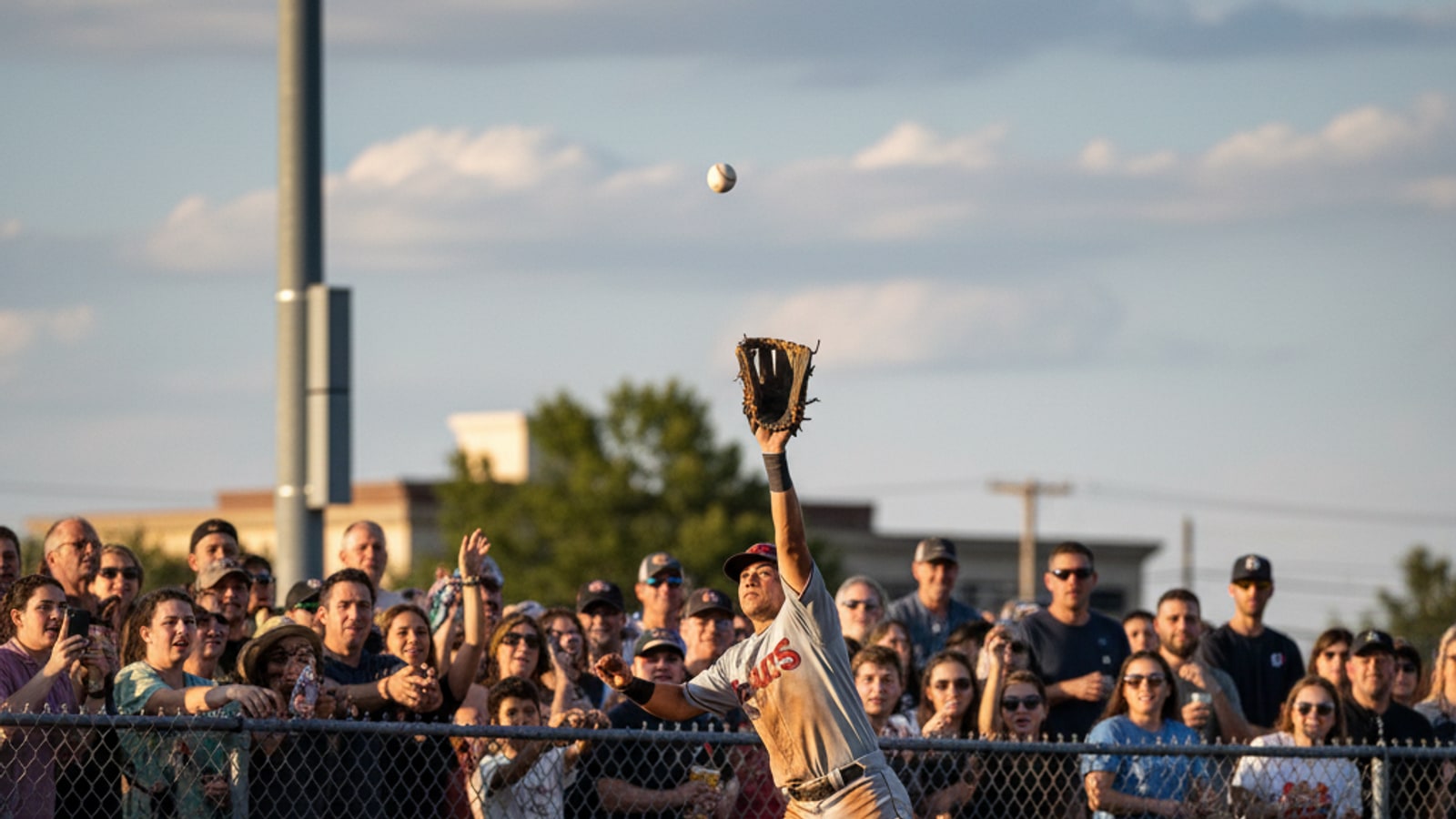 What happens if an outfielder catches a foul ball?