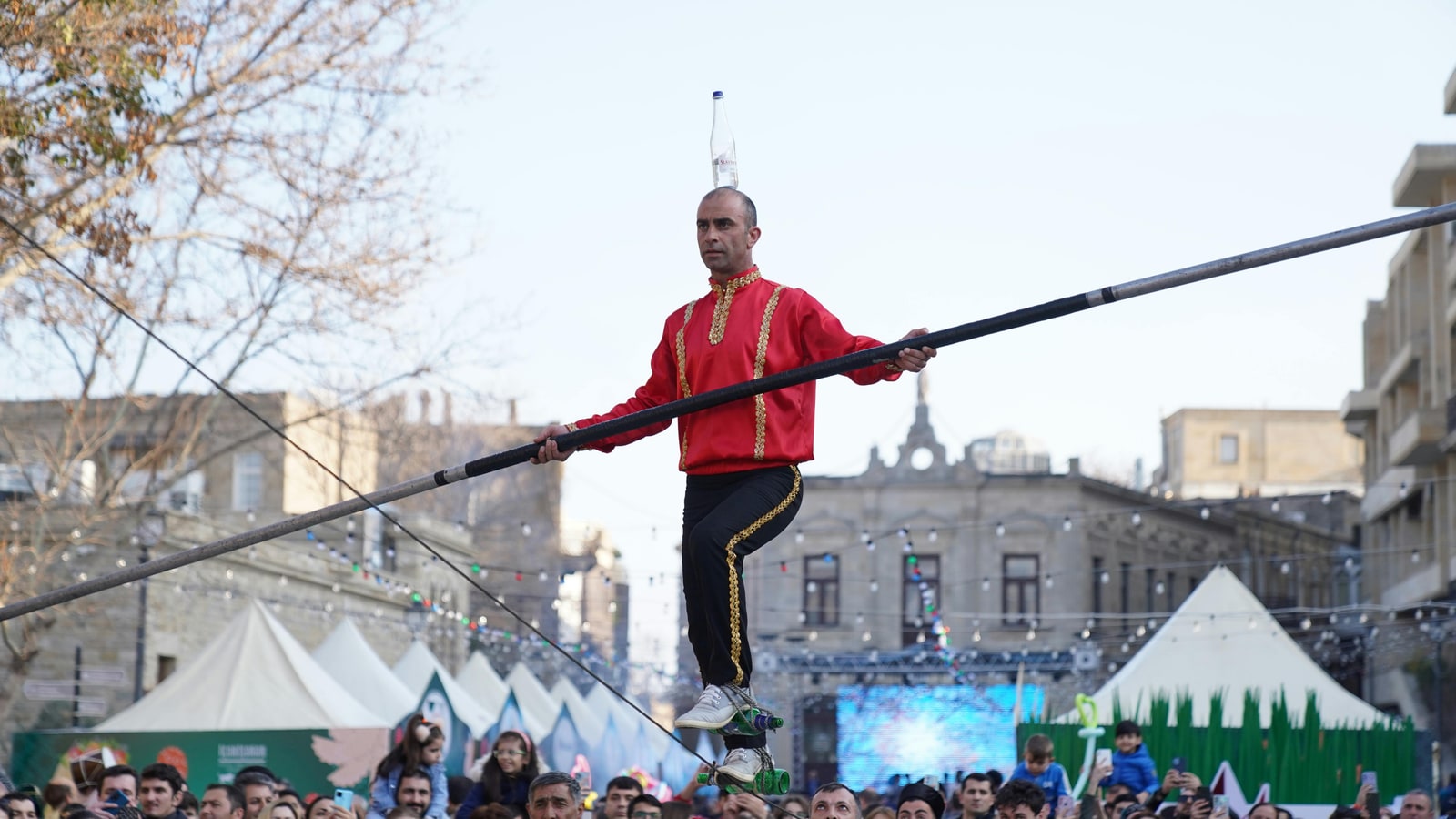 Why do tightrope walkers use pole physics?