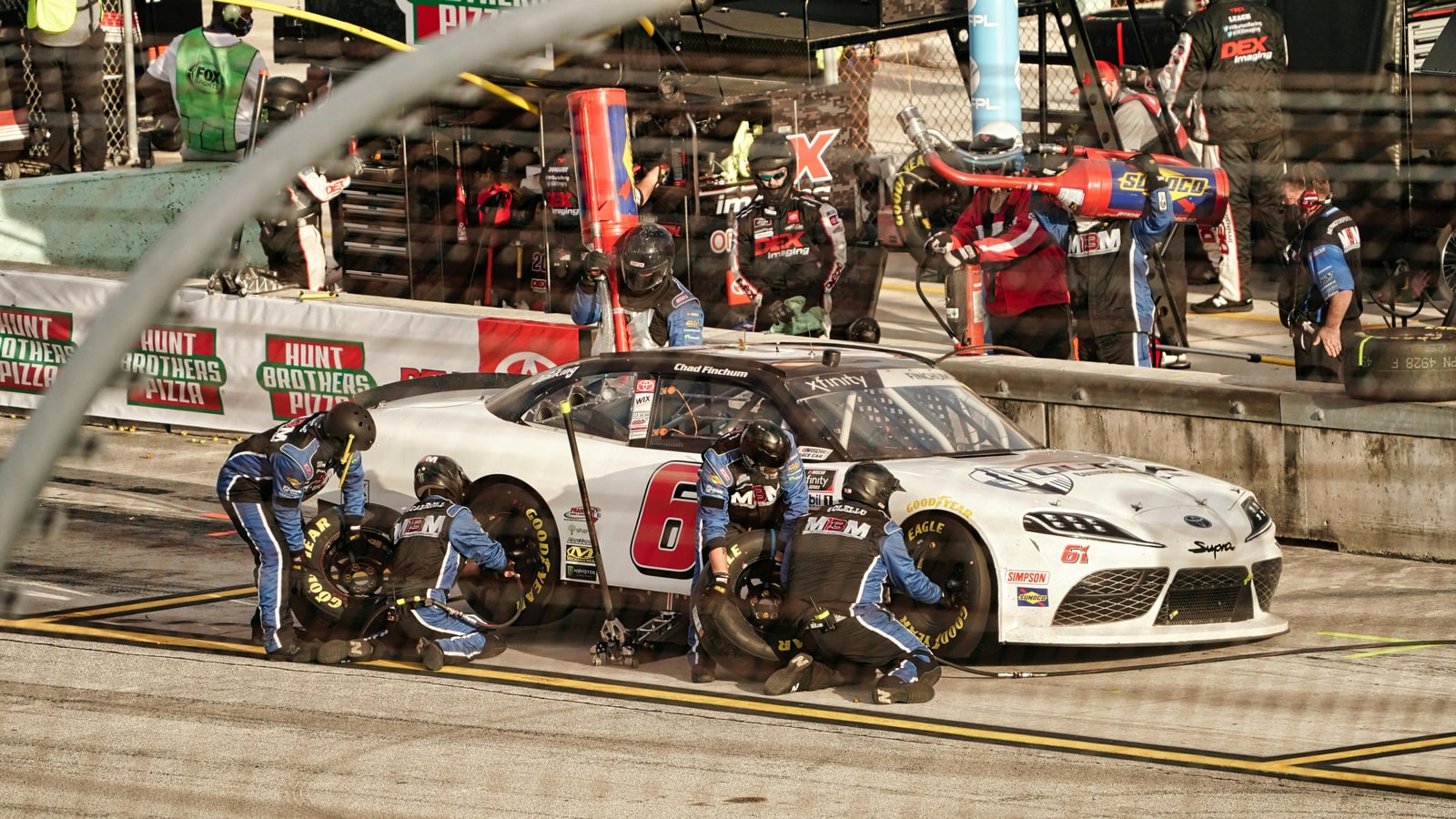 Why do Nascar players scrape and torch tires?