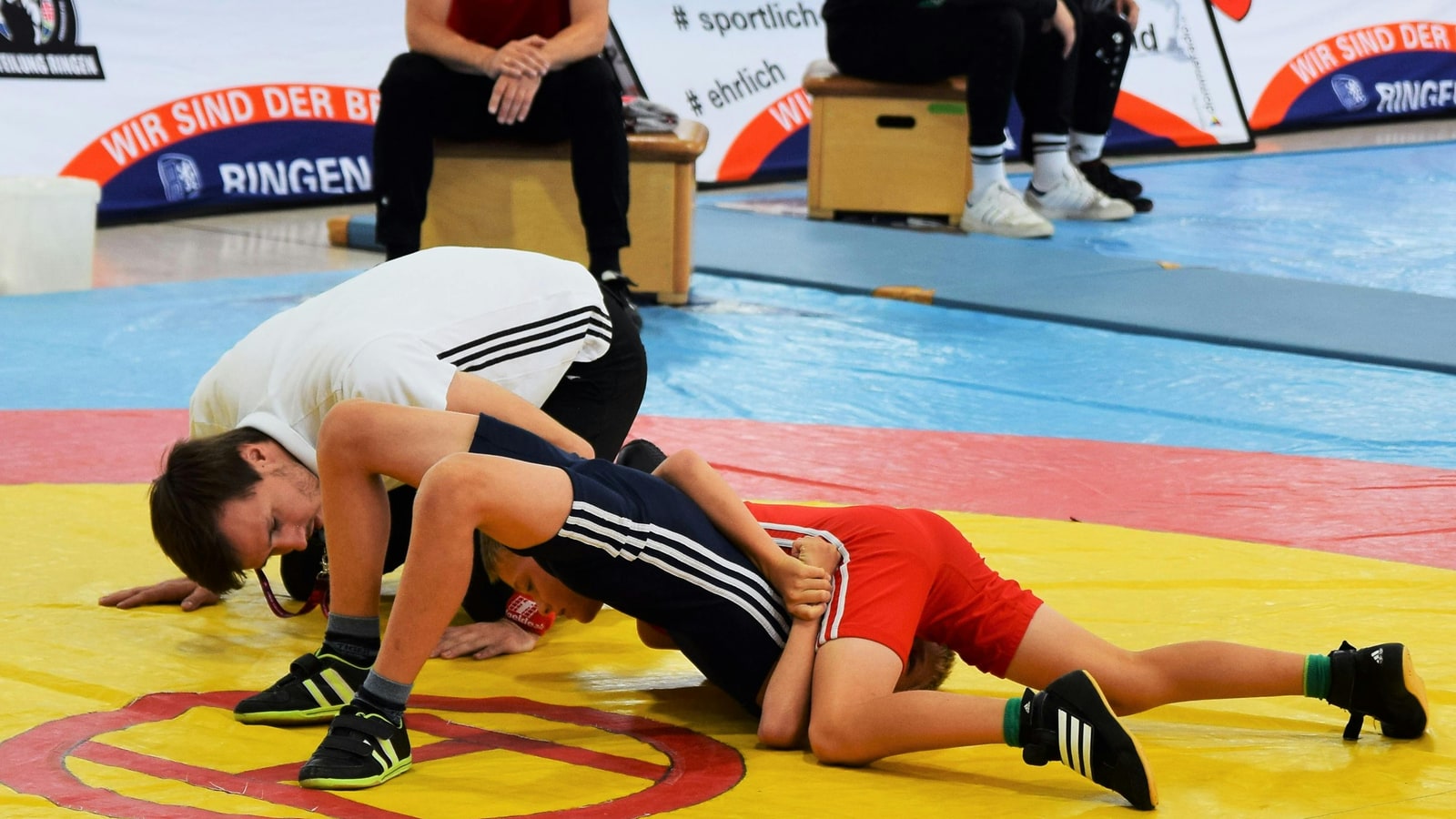 Why are wrestling boots so high?